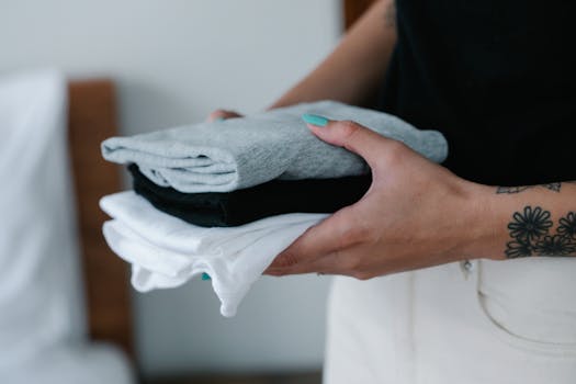 a person sorting through a pile of clothes